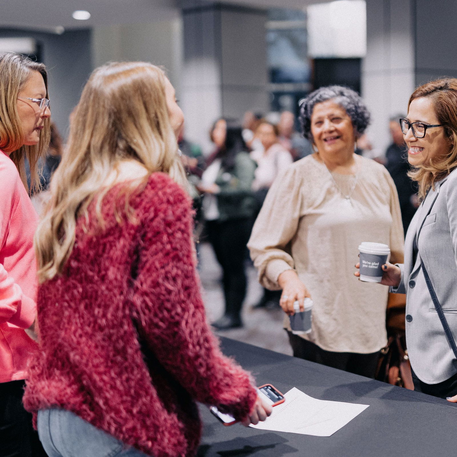 Women talking at a booth