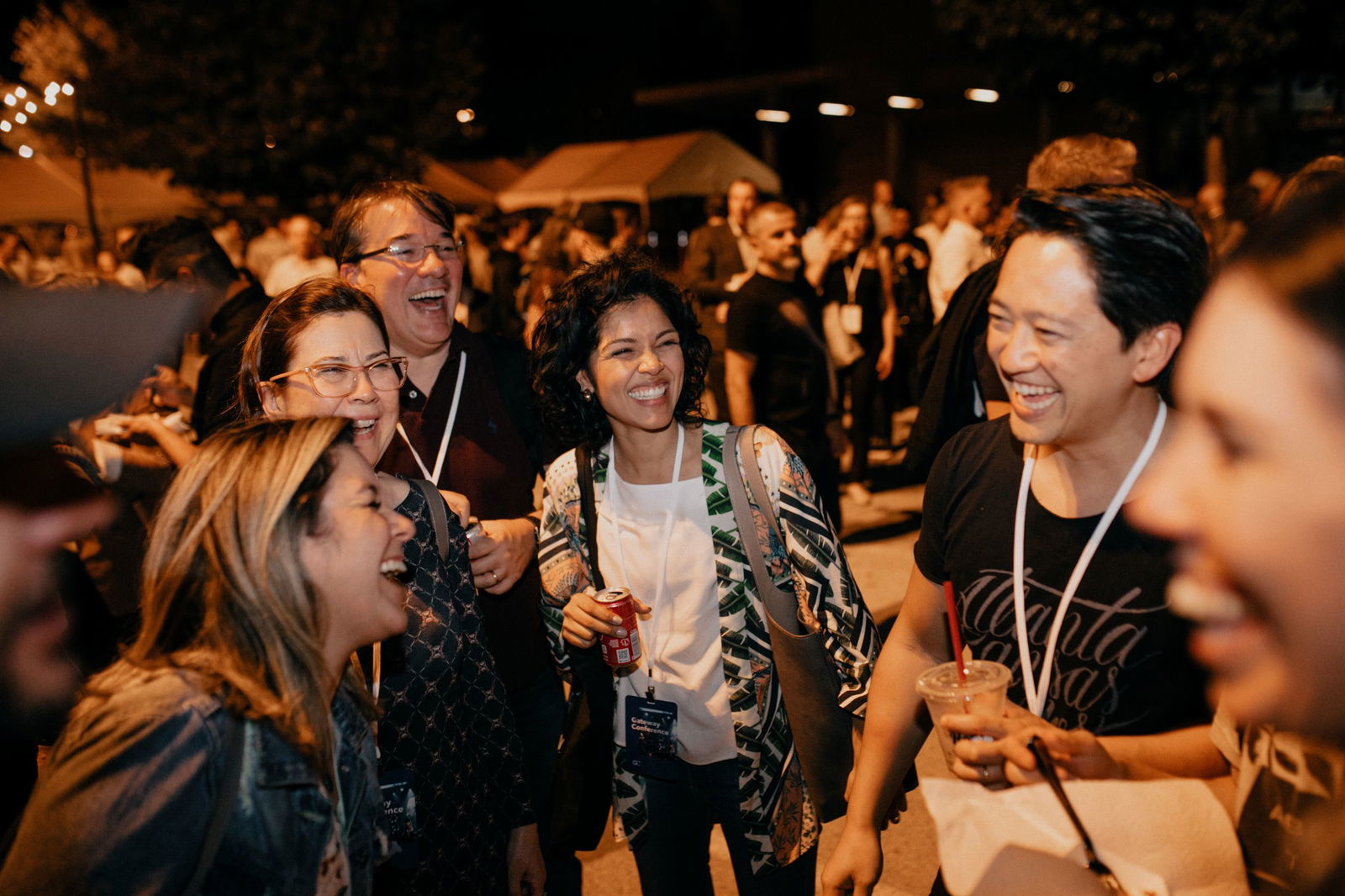 Man with hands up and eyes closed in a crowd