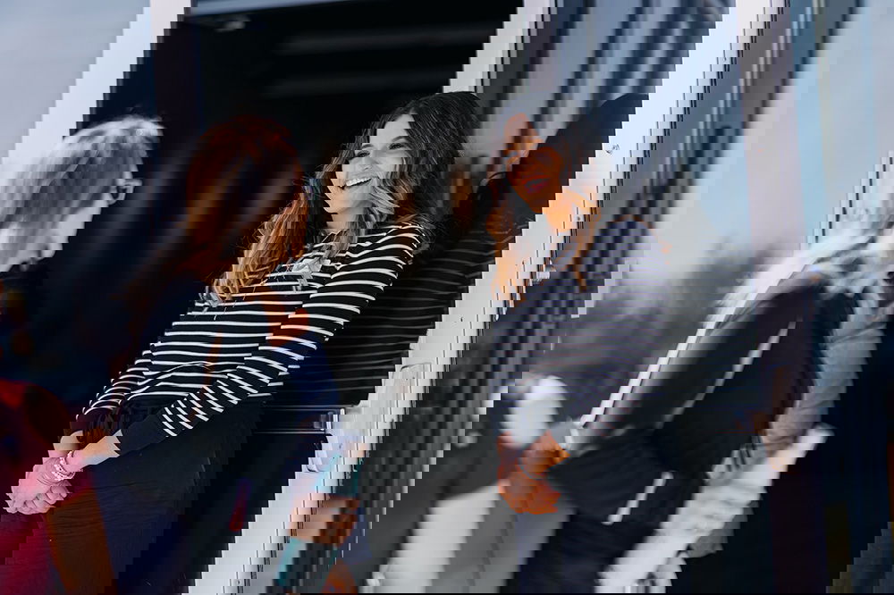 Woman greeting another woman at the church entrance